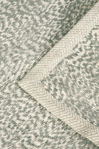 close up corner detail of leaf green throw
