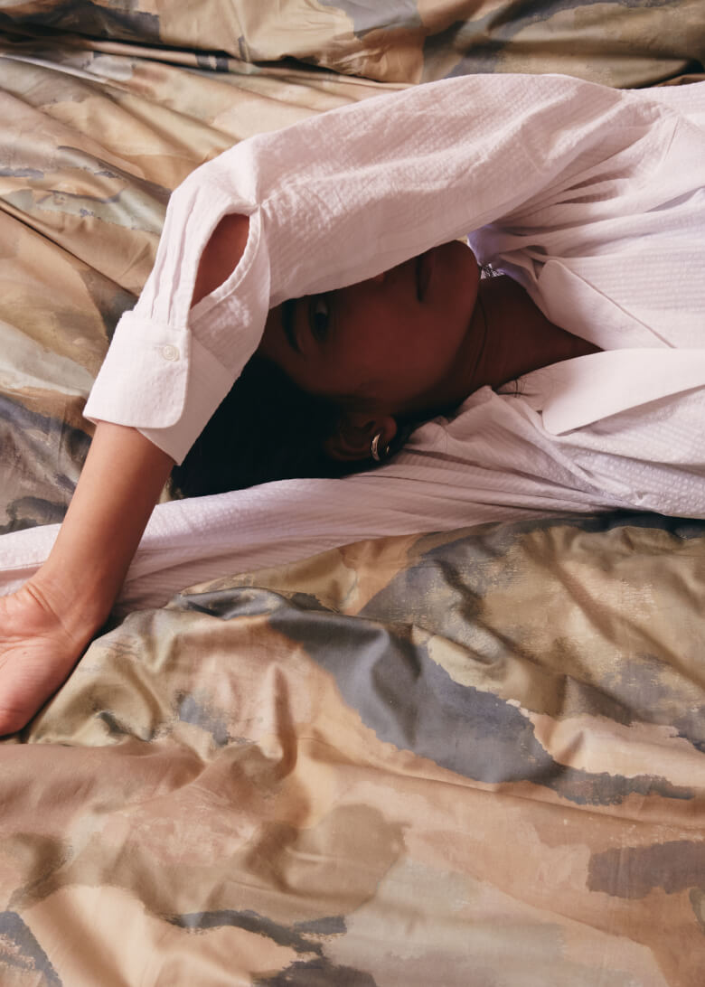 woman lying on printed duvet cover