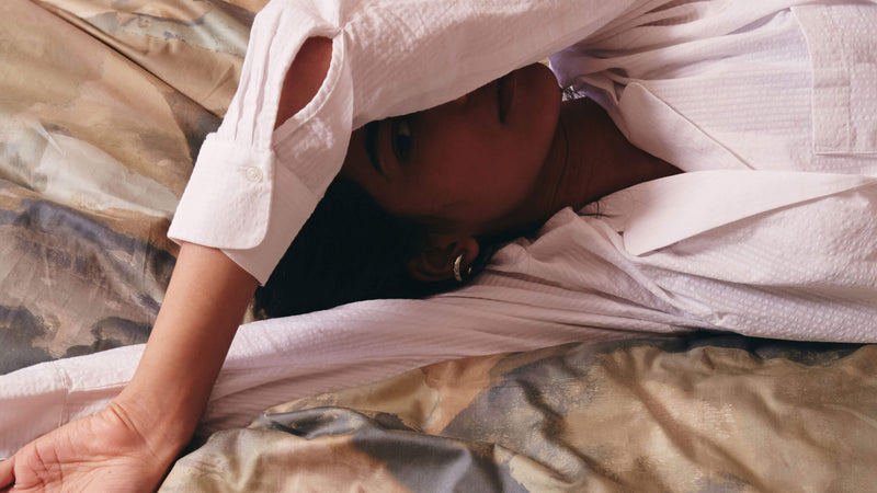 woman lying on printed duvet cover