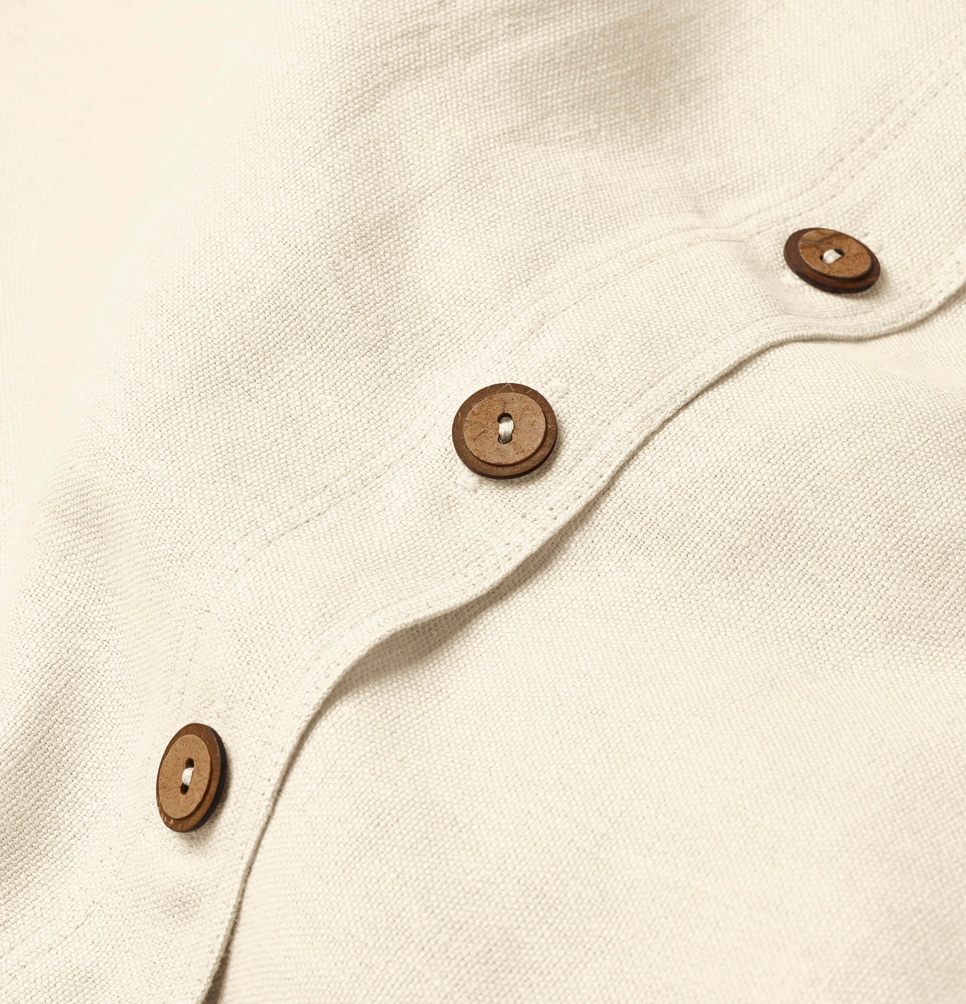 Back button detail of iridescent ivory linen cushion