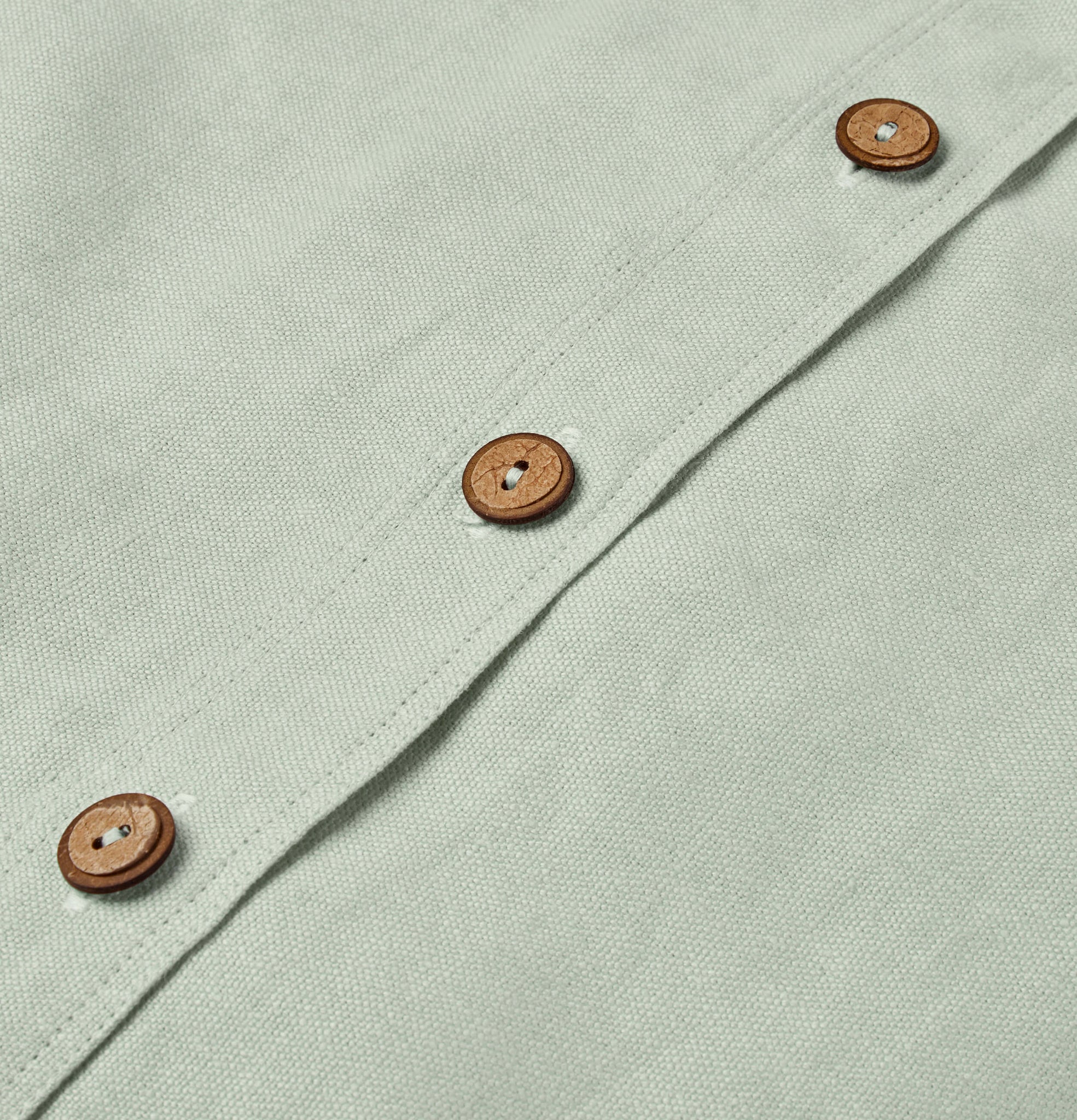 Button detail on spring blue linen cushion