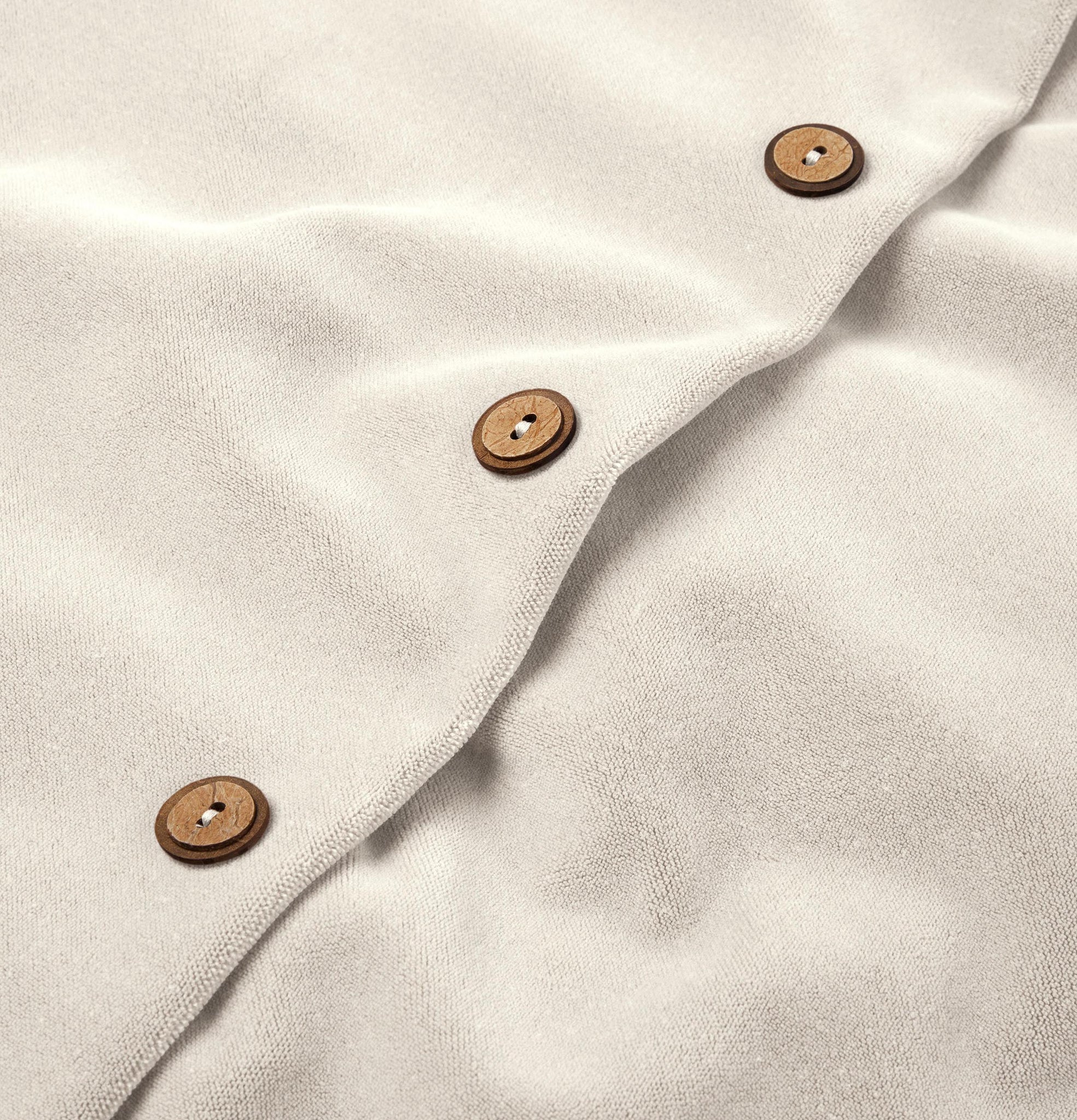 Button detail of cloudy white velvet cushion