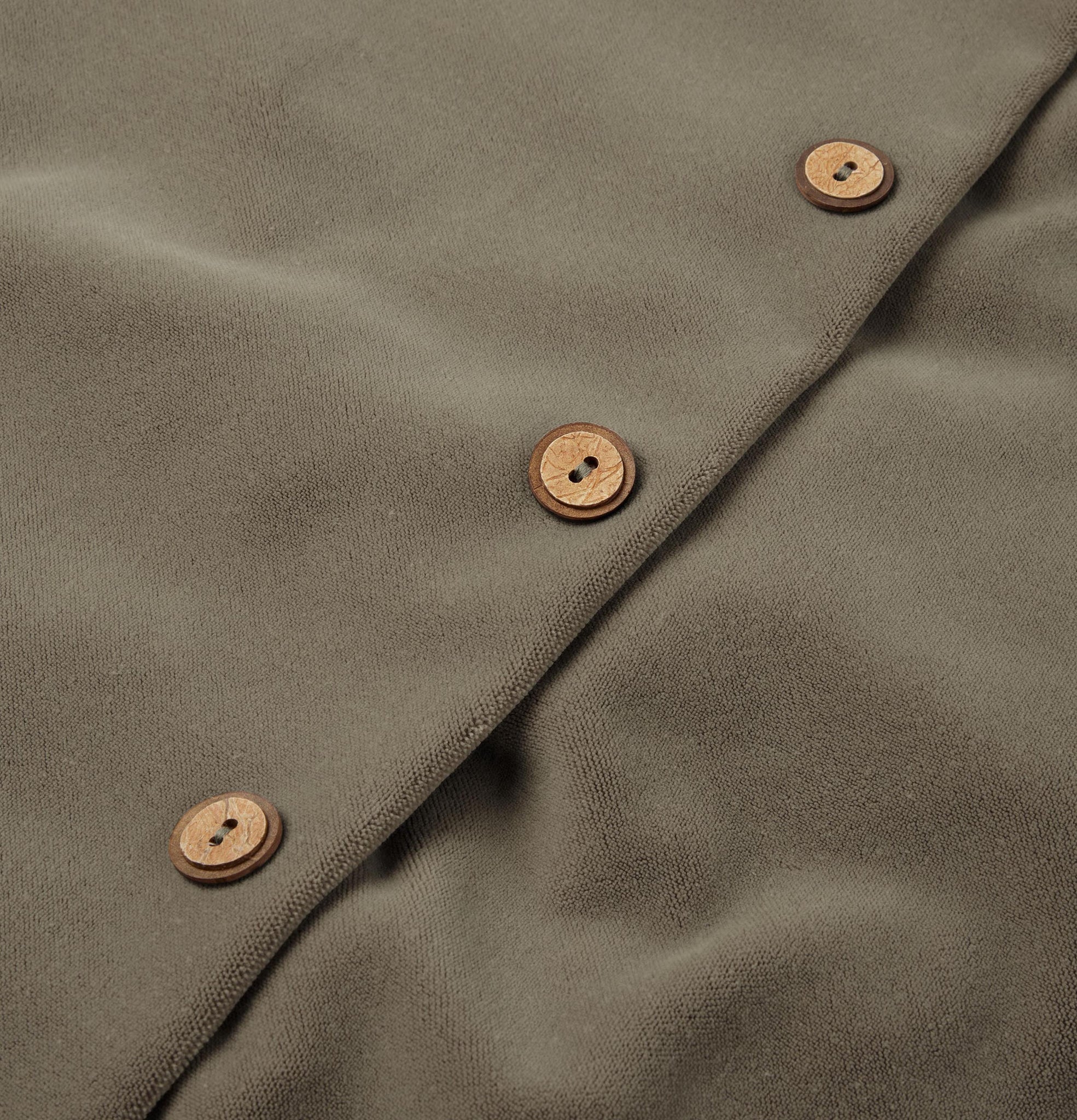 Button detail of dusk grey velvet cushion
