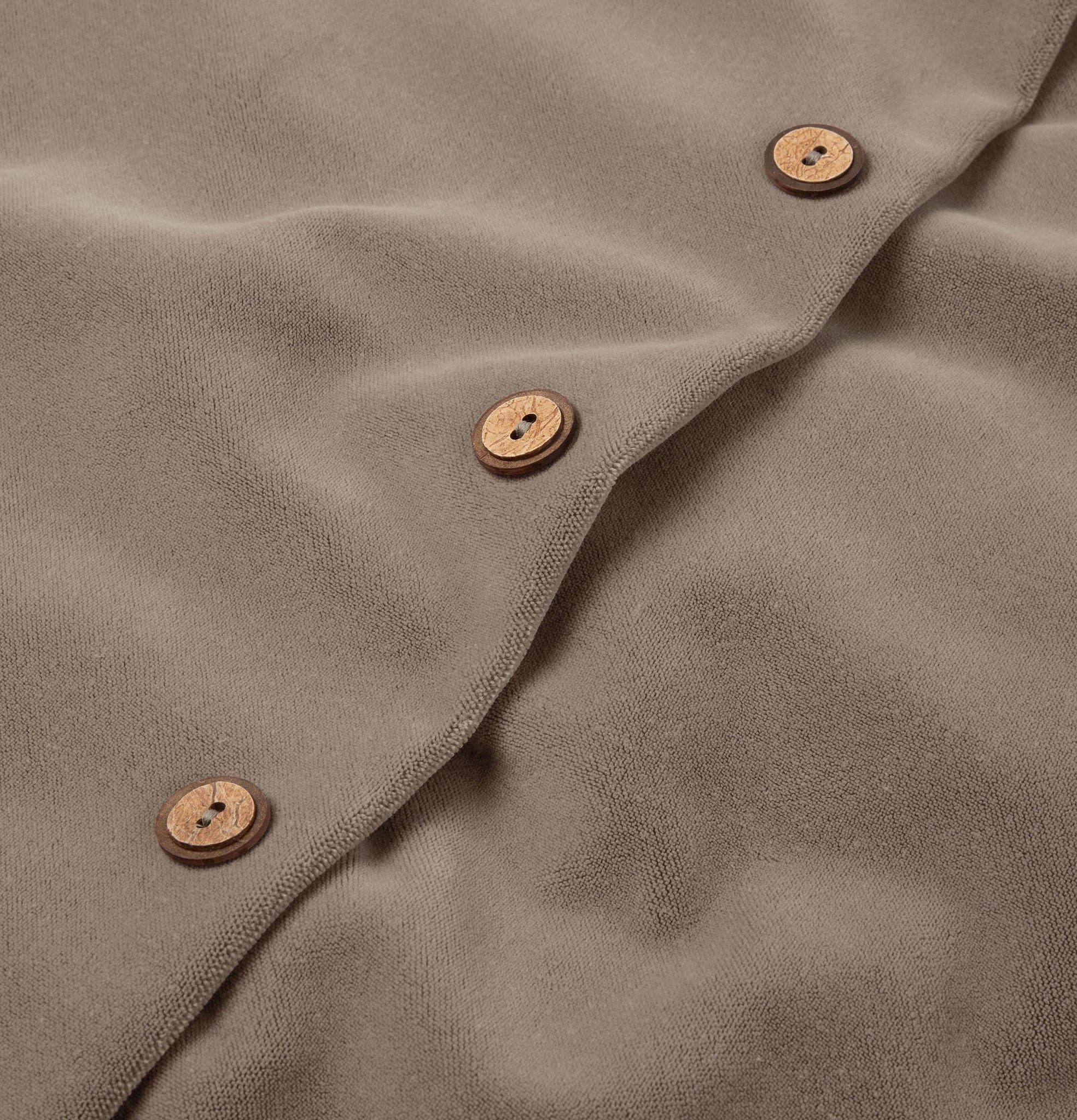 Button detail of harvest taupe velvet cushion