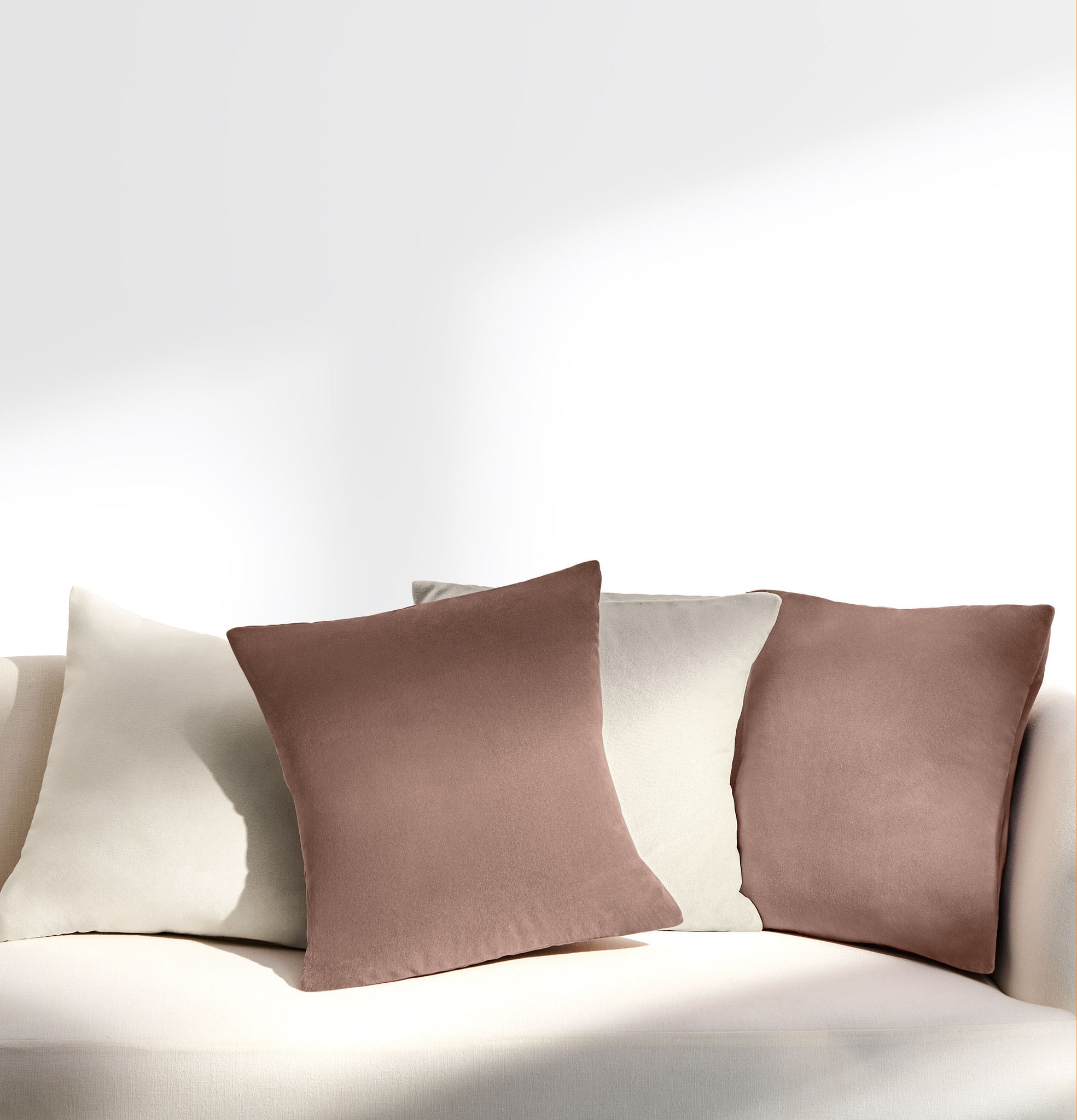 sunset pink and ivory velvet cushions on sofa