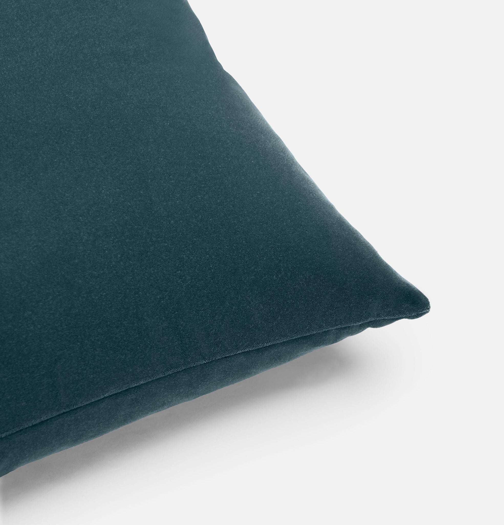 Corner detail of icy teal velvet cushion